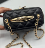 Chanel black quilted synthetic leather crossbody bag with gold chain strap and Chanel logo detail.