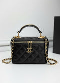 Chanel black quilted synthetic leather vanity crossbody bag with gold chain strap and CC logo.
