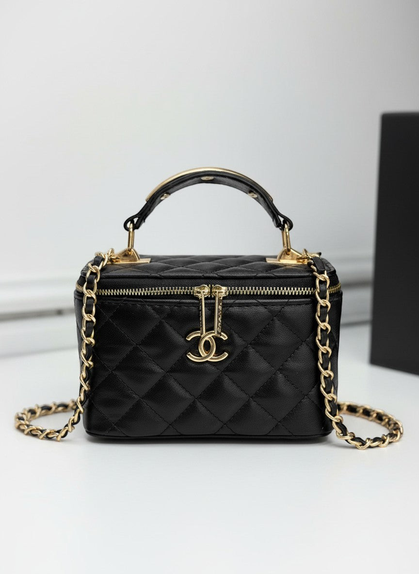 Chanel black quilted synthetic leather vanity crossbody bag with gold chain strap and CC logo.