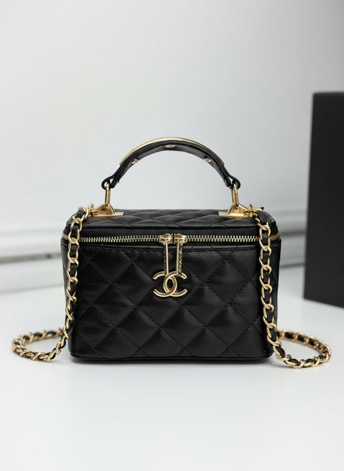 Chanel black quilted synthetic leather vanity crossbody bag with gold chain strap and CC logo.