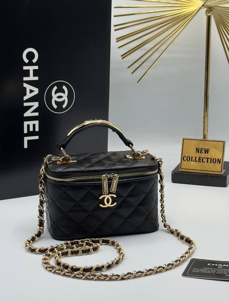 Chanel black quilted synthetic leather vanity crossbody bag with gold chain strap and CC logo detail.