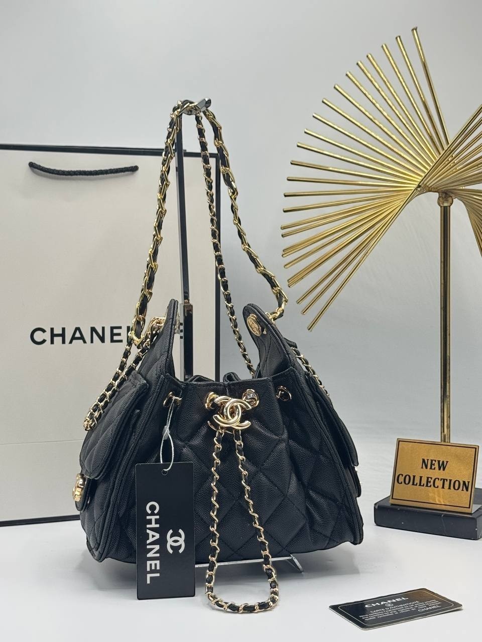 Divabags black grained calfskin Chanel 25 bucket bag with gold chain strap and CC logo clasp.